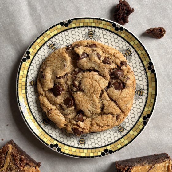 A chocolate chip cookie on a bee-patterned plate